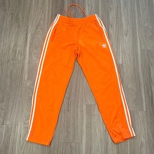Orange track adidas pants